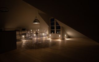 dining area at night at The Penthouse